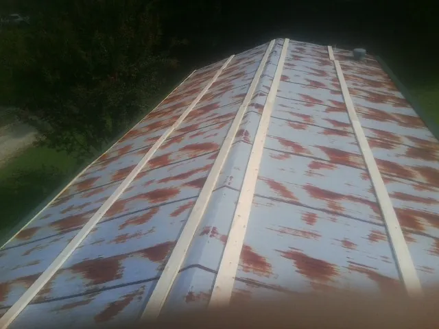 Rusted metal roof panels with new wood purlins before replacement — Storm Damage Roof Repair in Frazier Park by Roofing Brothers